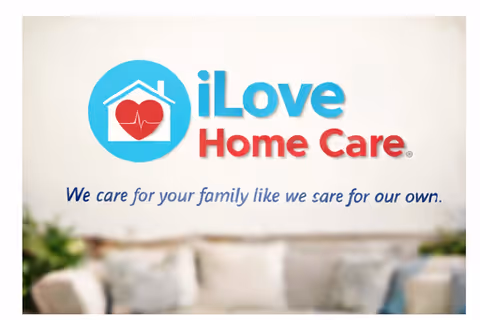 Indoor lobby area featuring iLove Home Care sign and blurred seating in foreground.