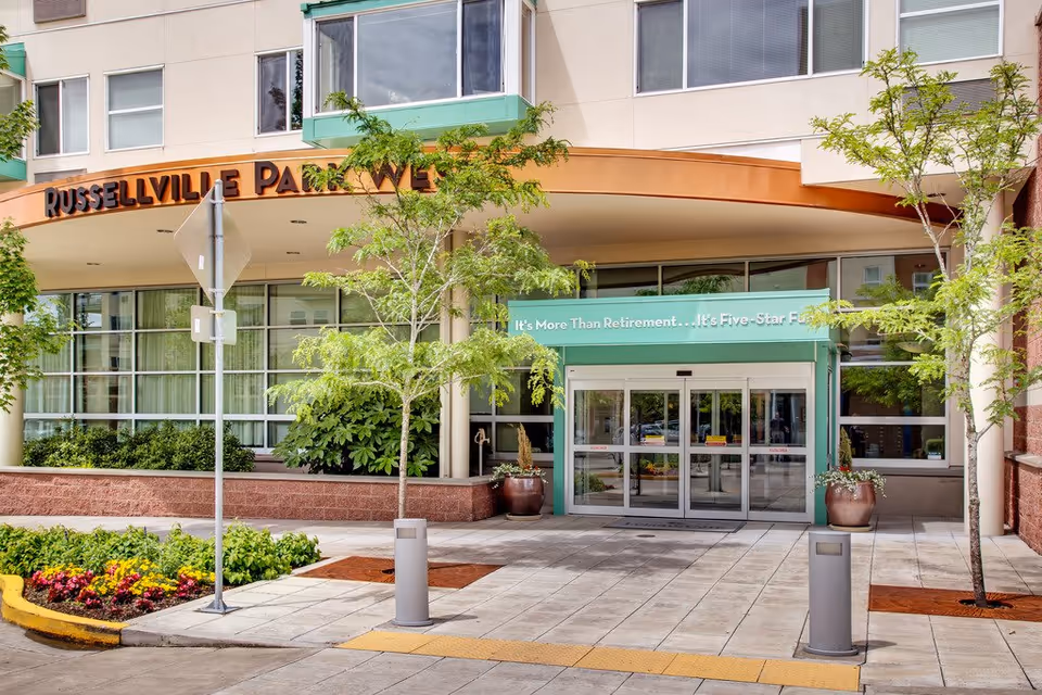 Exterior view of Russellville Park entrance with glass doors and green awning