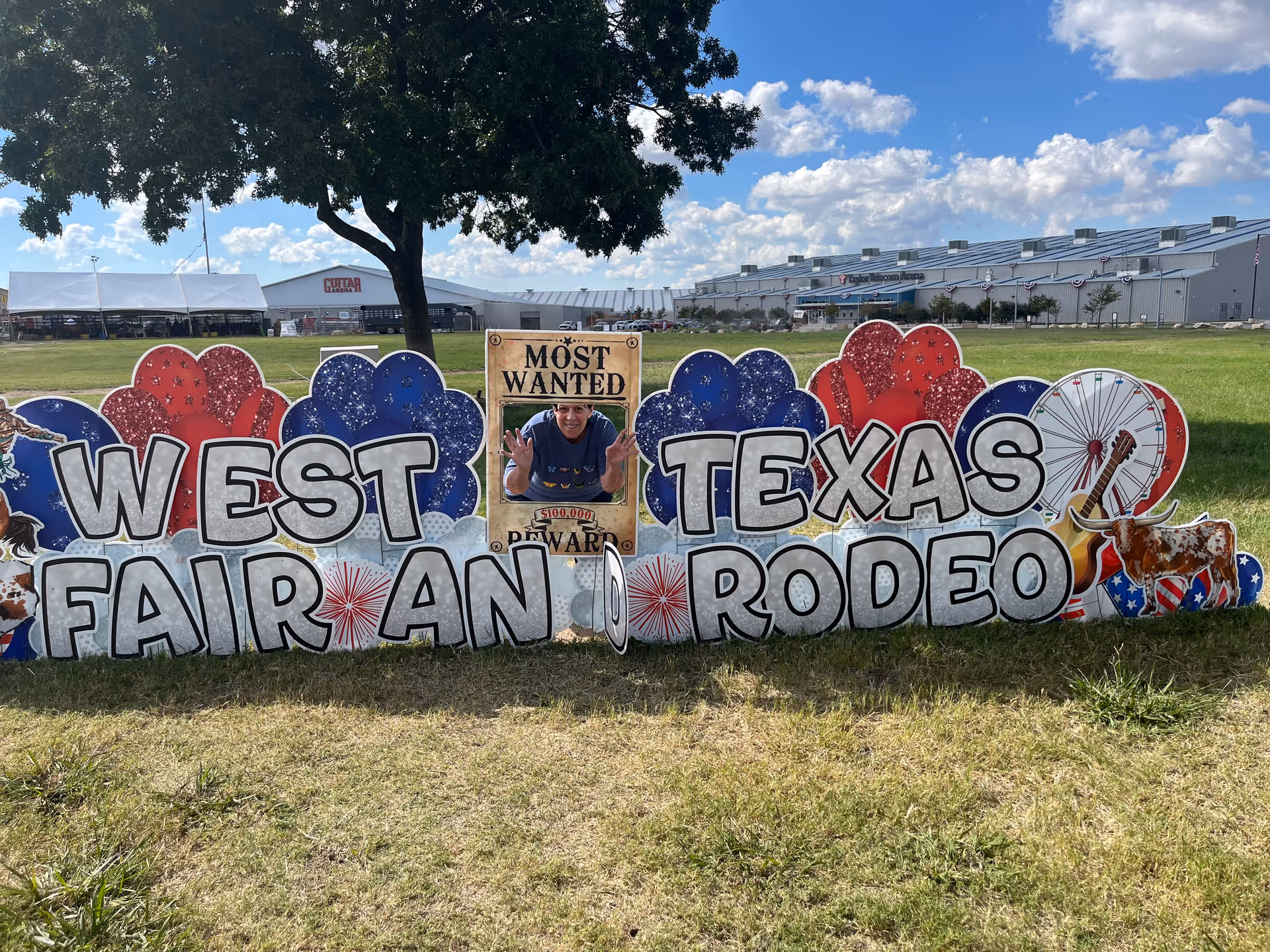 Bright outdoor sign reading West Texas Fair and Rodeo, with a central photo cutout