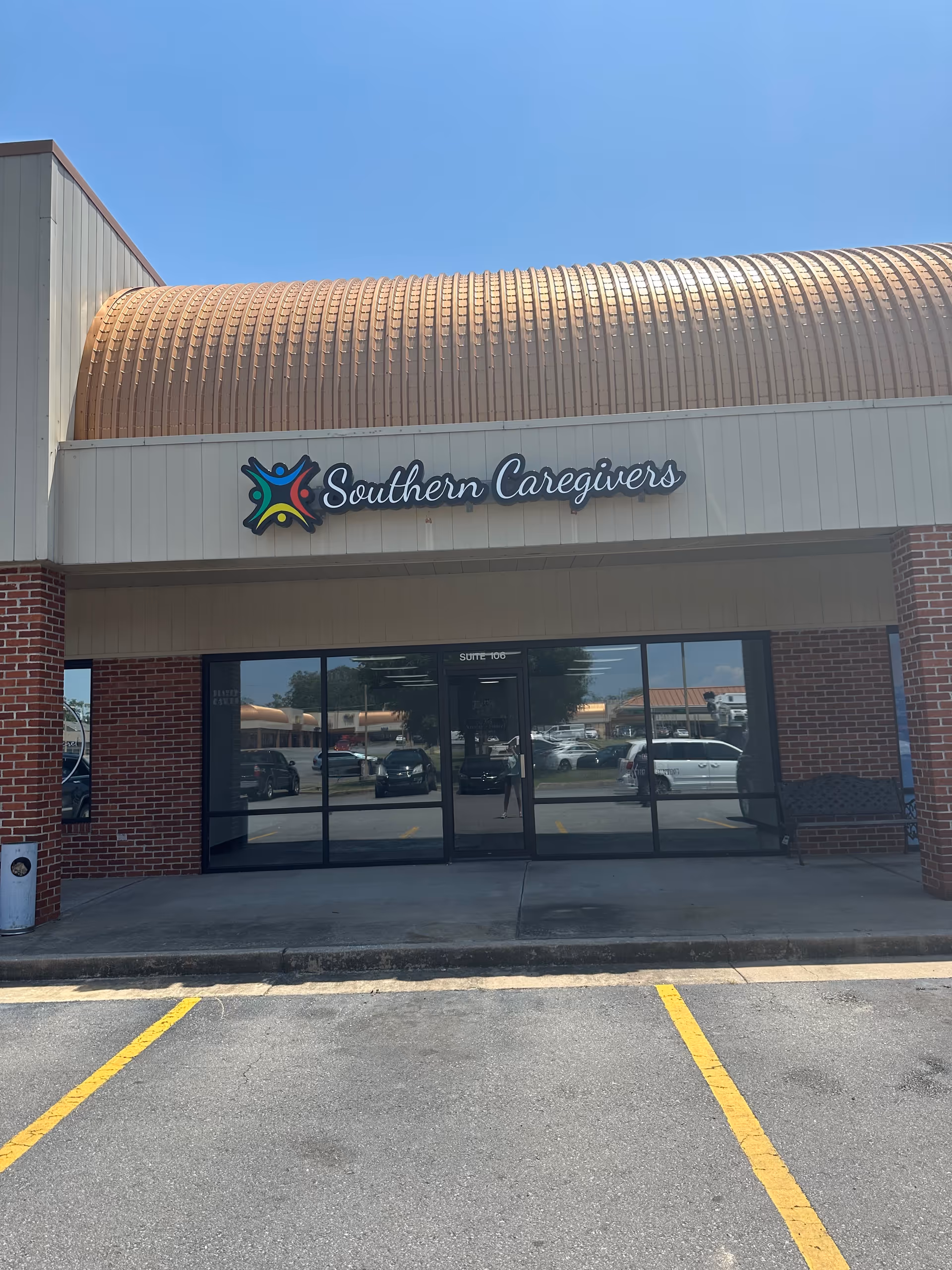 Front view of Southern Caregivers building with glass entrance and copper curved roof