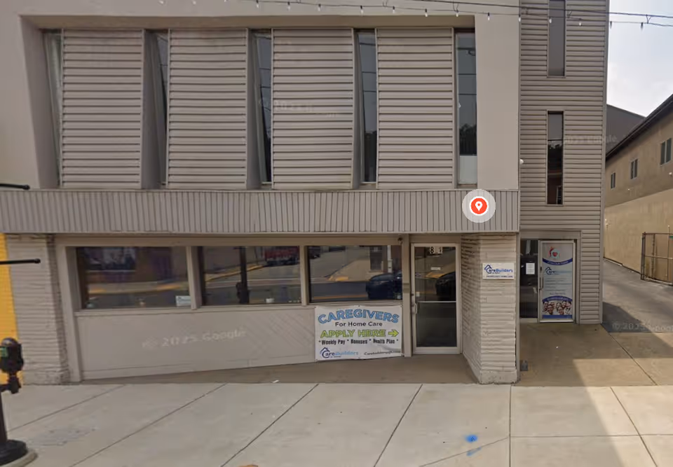 Front facade of CareBuilders At Home building with storefront windows and signage.