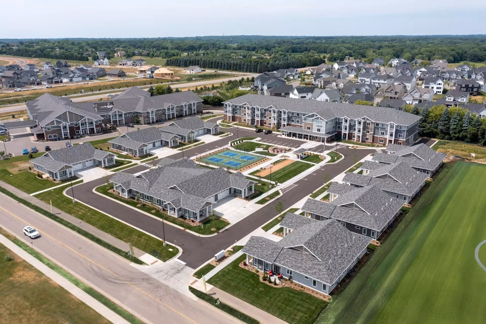 Aerial view of The Fields by New Perspective senior living campus with buildings and amenities.