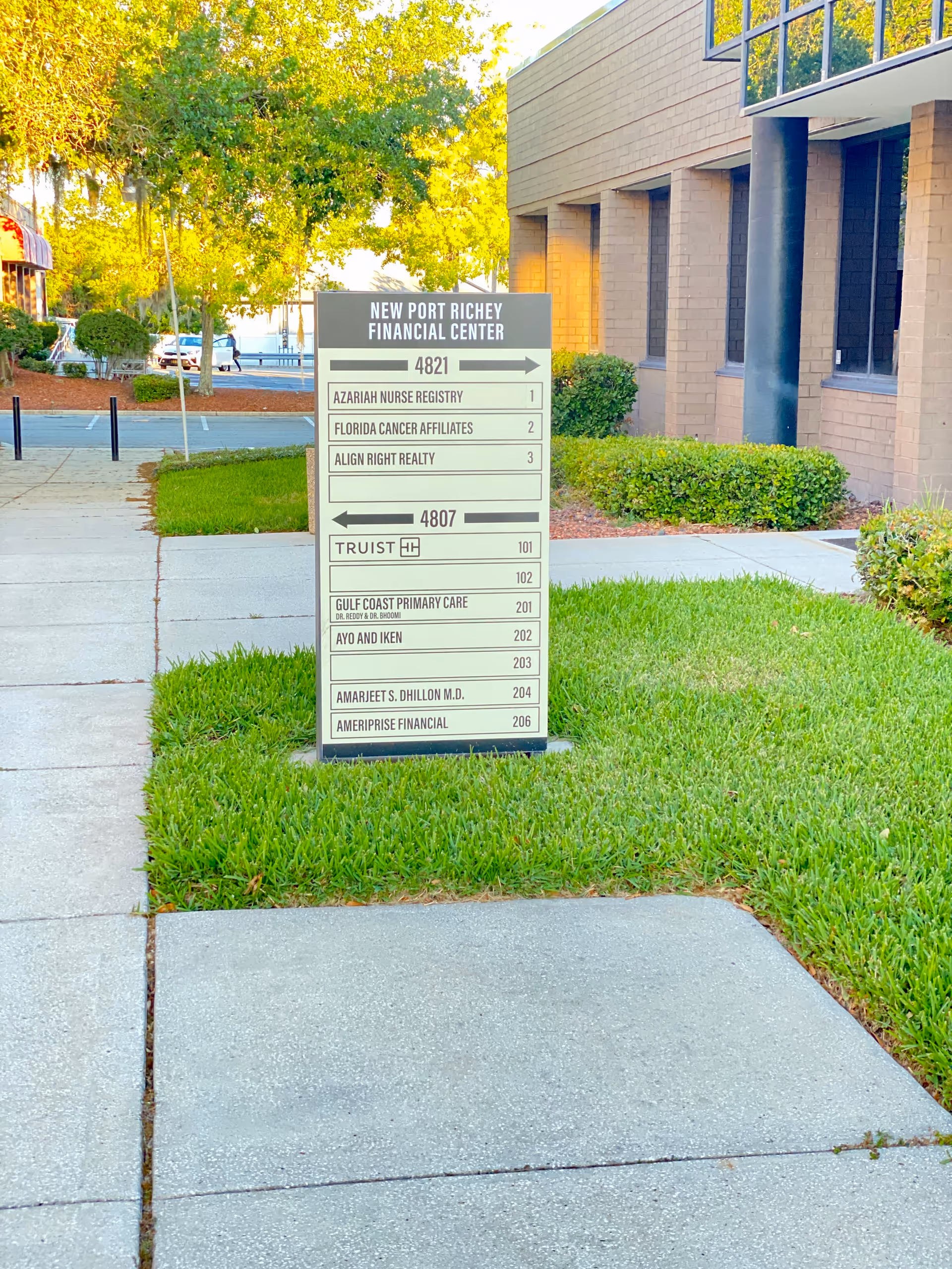 Exterior view of Azariah Nurse Registry building with a directory sign and green lawn.