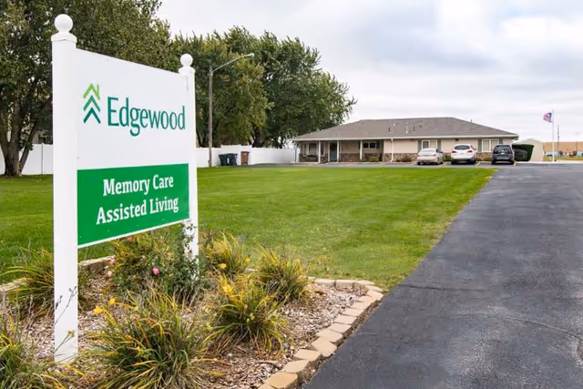 Edgewood sign for Memory Care Assisted Living with building and parking lot in background.
