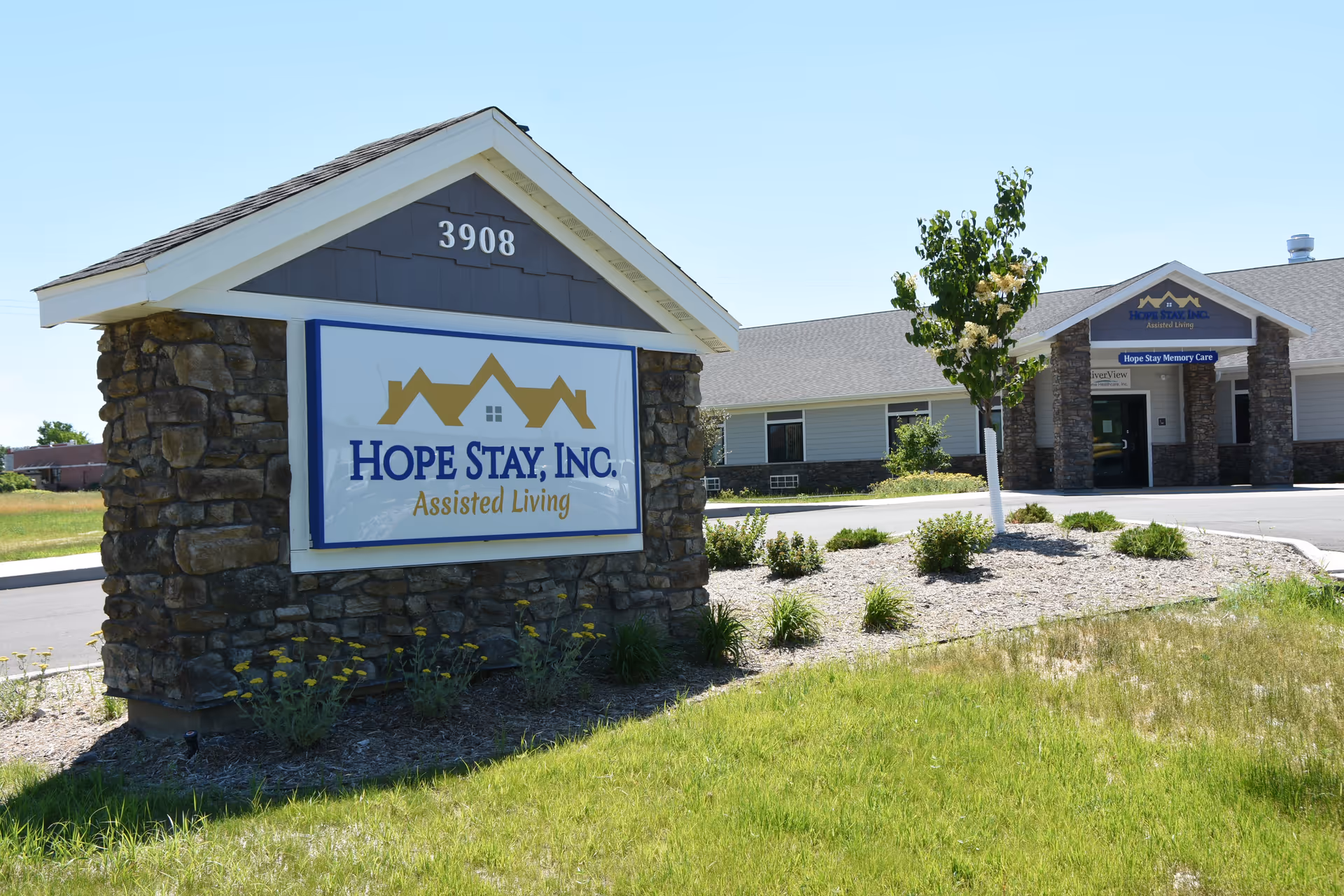 Exterior view of Hope Stay, Inc. sign and the front entrance of the memory care facility.