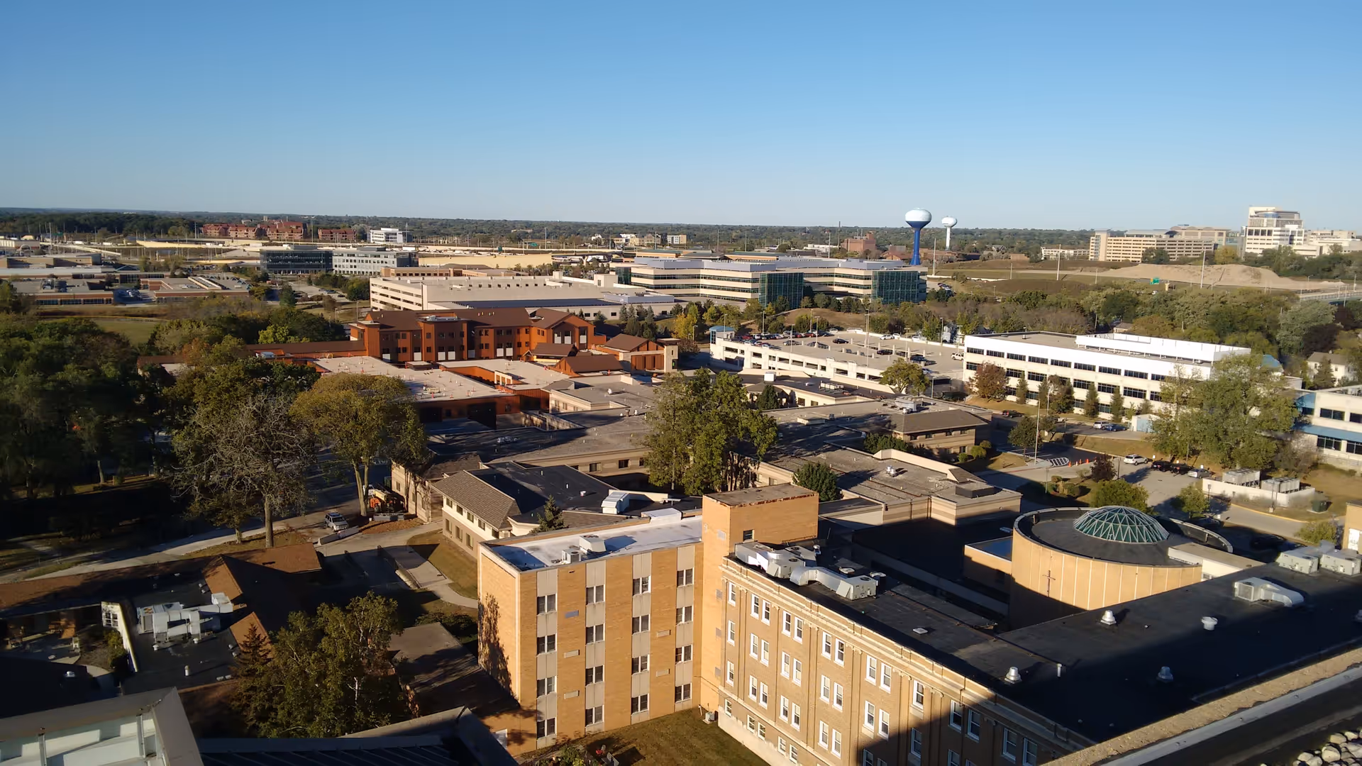 Aerial view of a senior living campus with brick buildings and green spaces.