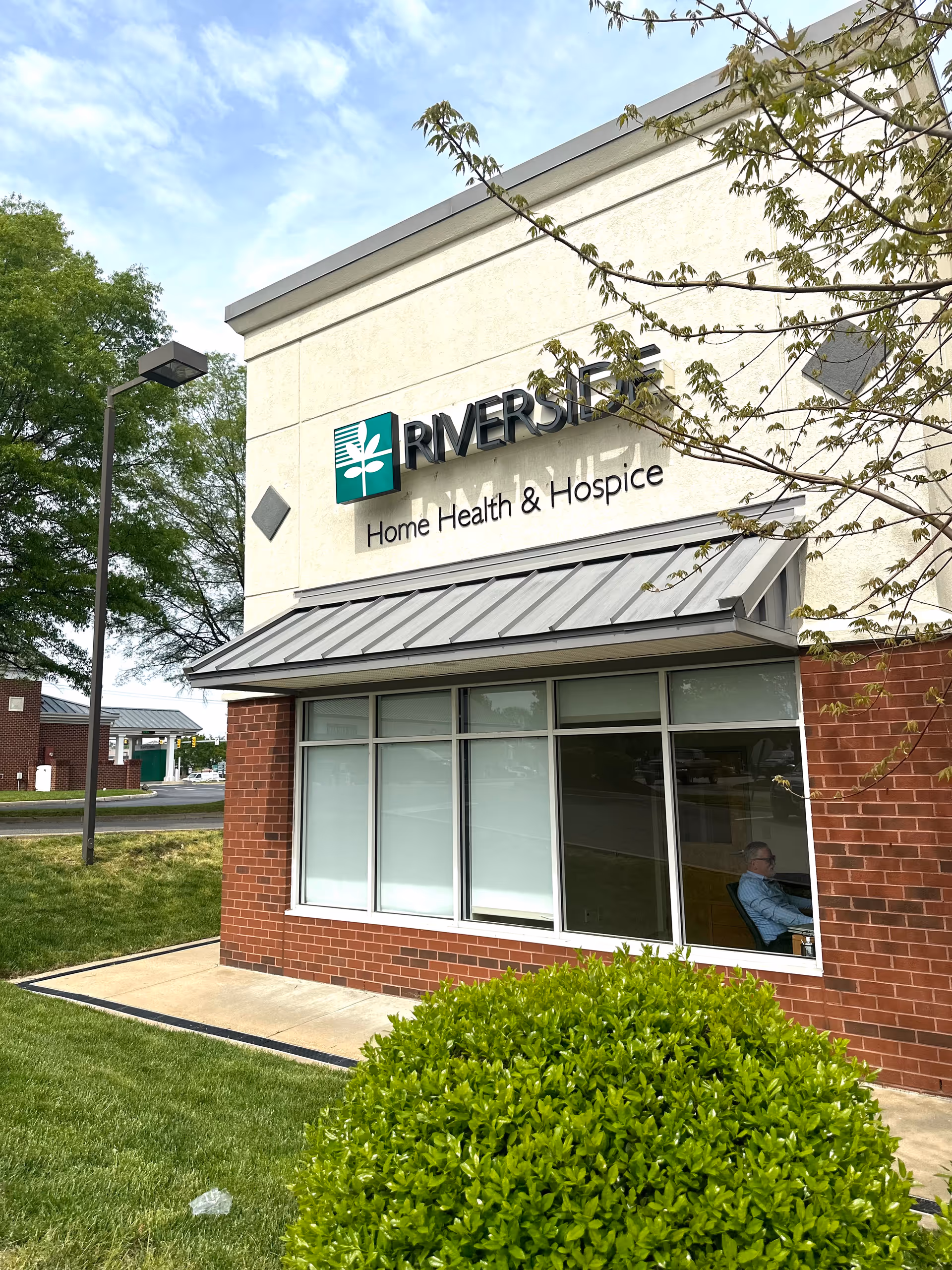 Exterior view of Riverside Home Health & Hospice building with large windows.