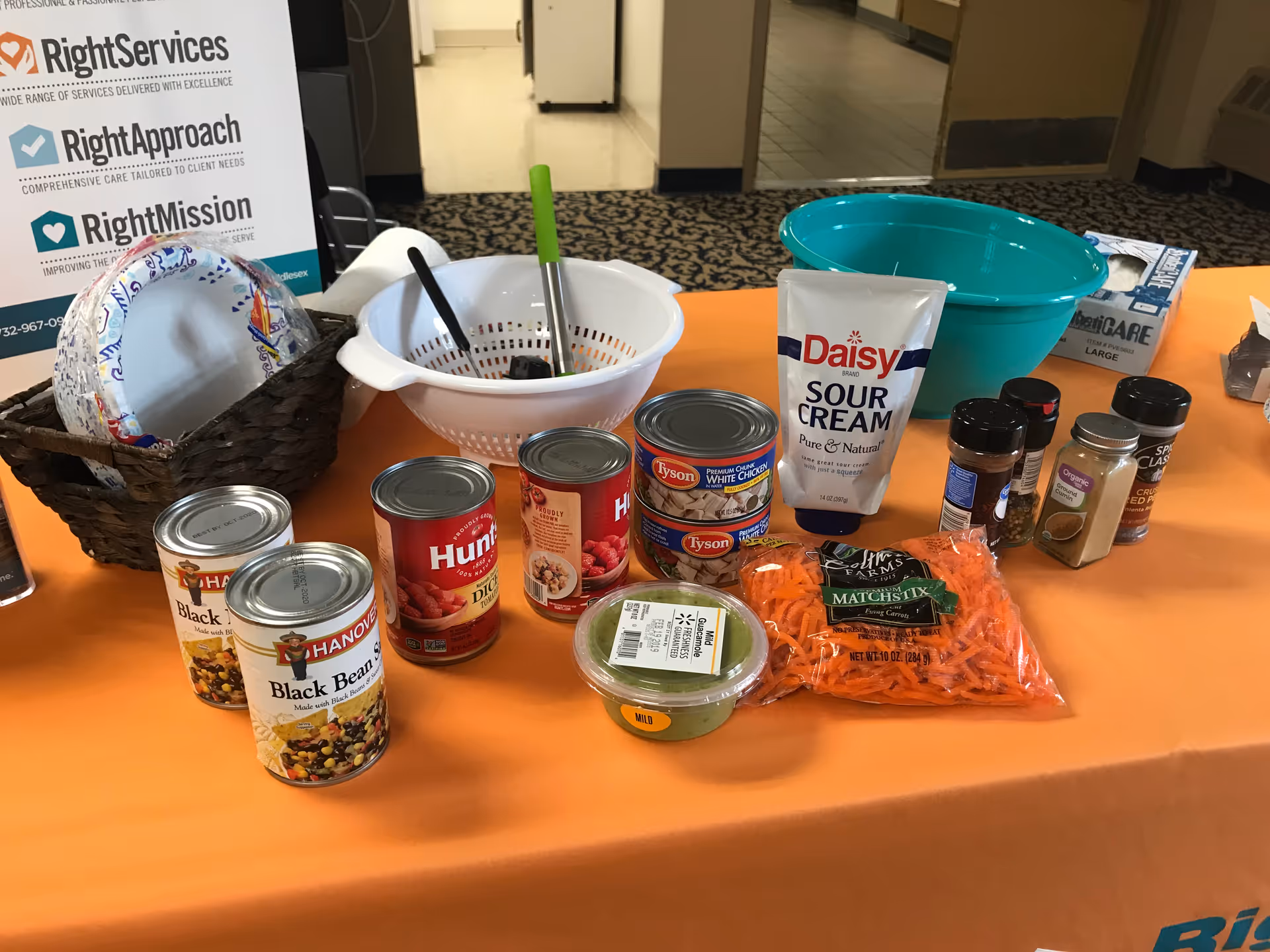 Table display of canned goods and kitchen supplies in a Right at Home Iselin facility.