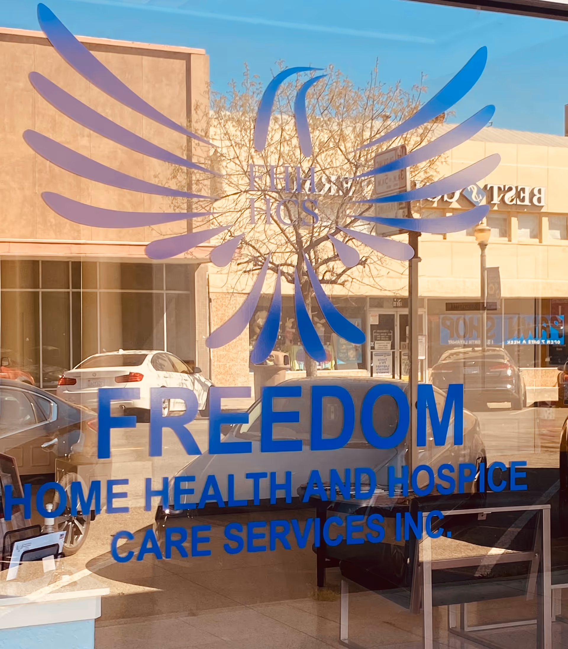 Glass storefront shows Freedom Home Health and Hospice Care Services Inc. logo and sign.