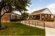 Exterior of The Villa at Mountain View with brick front and covered entrance ramp.