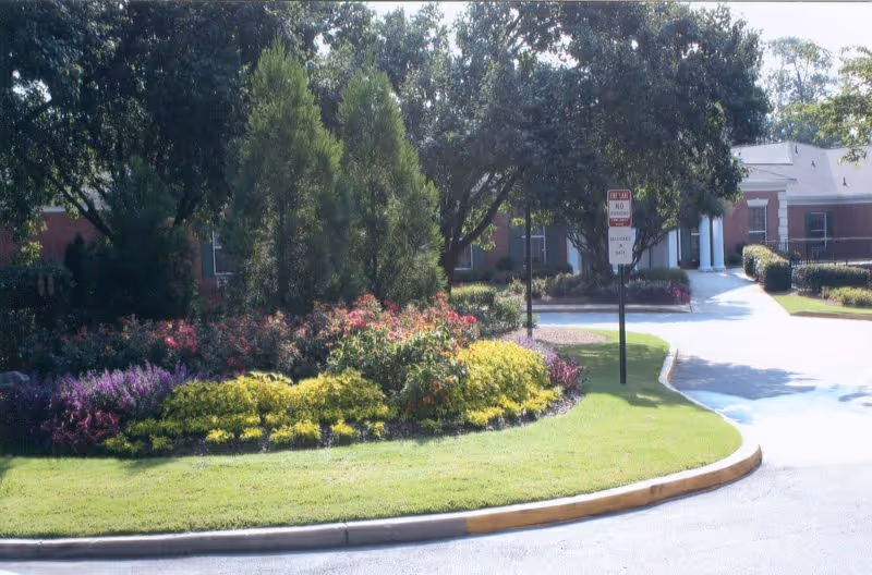 Exterior view of Sandy Springs Center for Nursing and Healing with landscaped entrance and driveway.