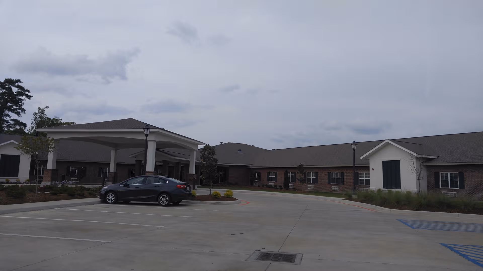 Exterior view of Golden Age Healthcare and Rehabilitation Center with brick facade and covered entrance.