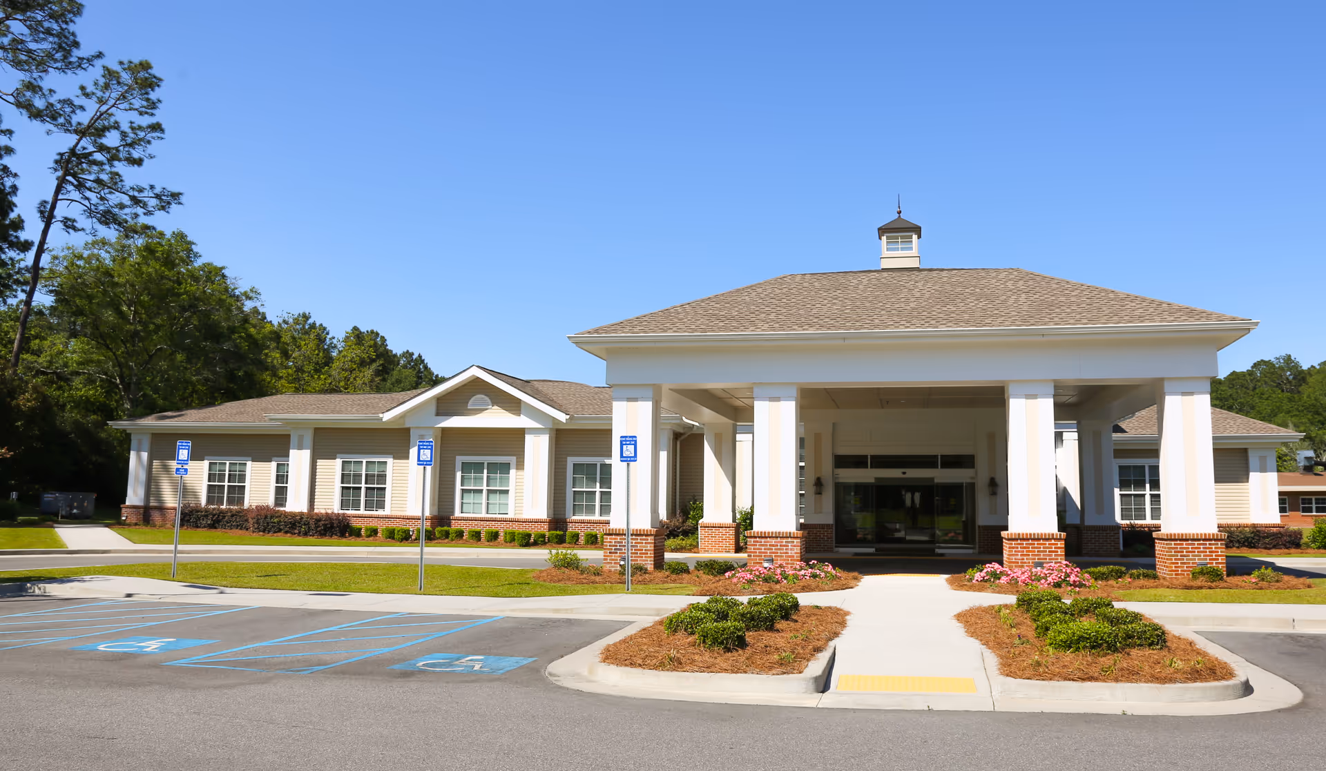 Exterior view of Vista Park Health and Rehabilitation front entrance with white columns and landscaping