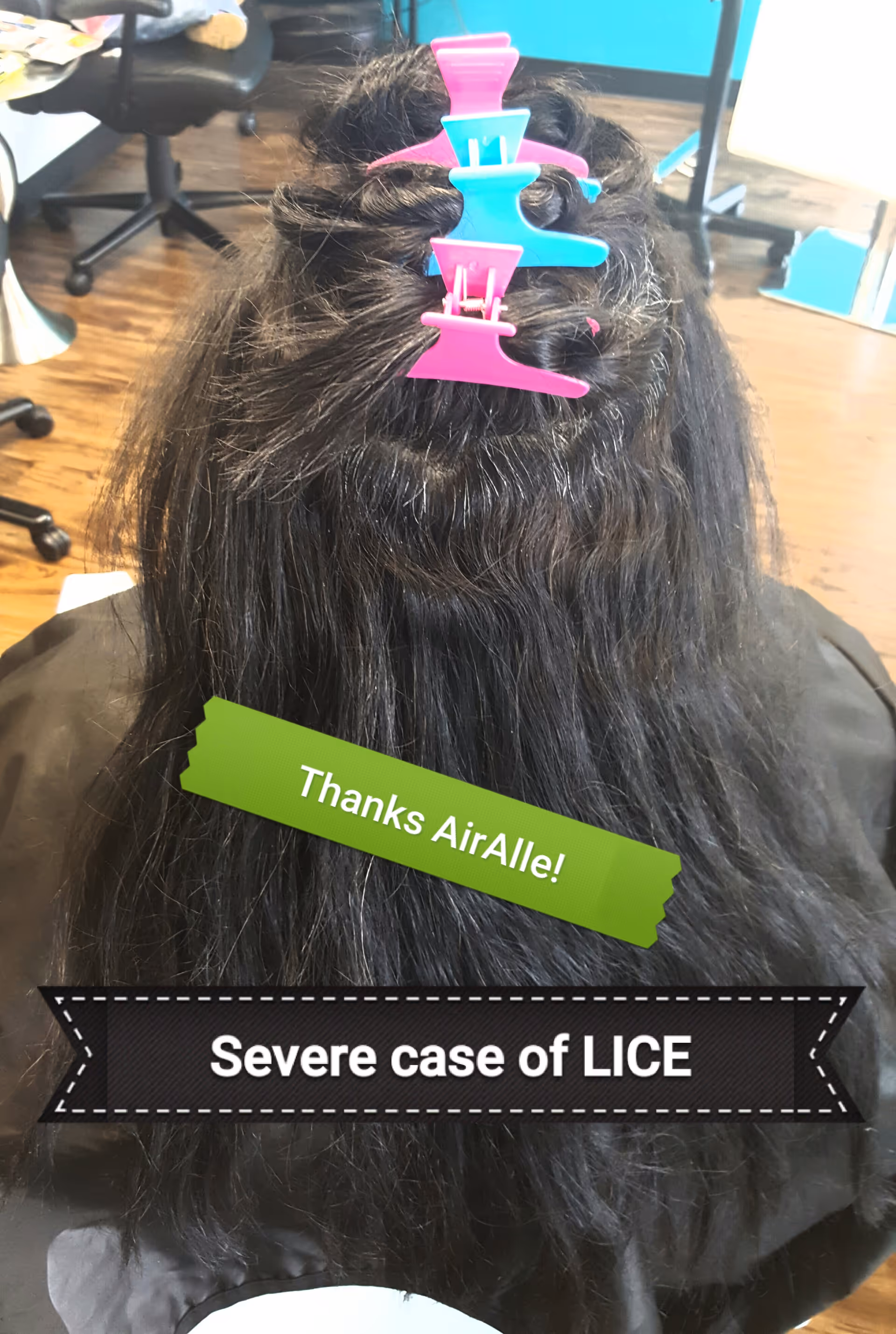 Back view of a person getting hair treatment with colorful clips in a salon