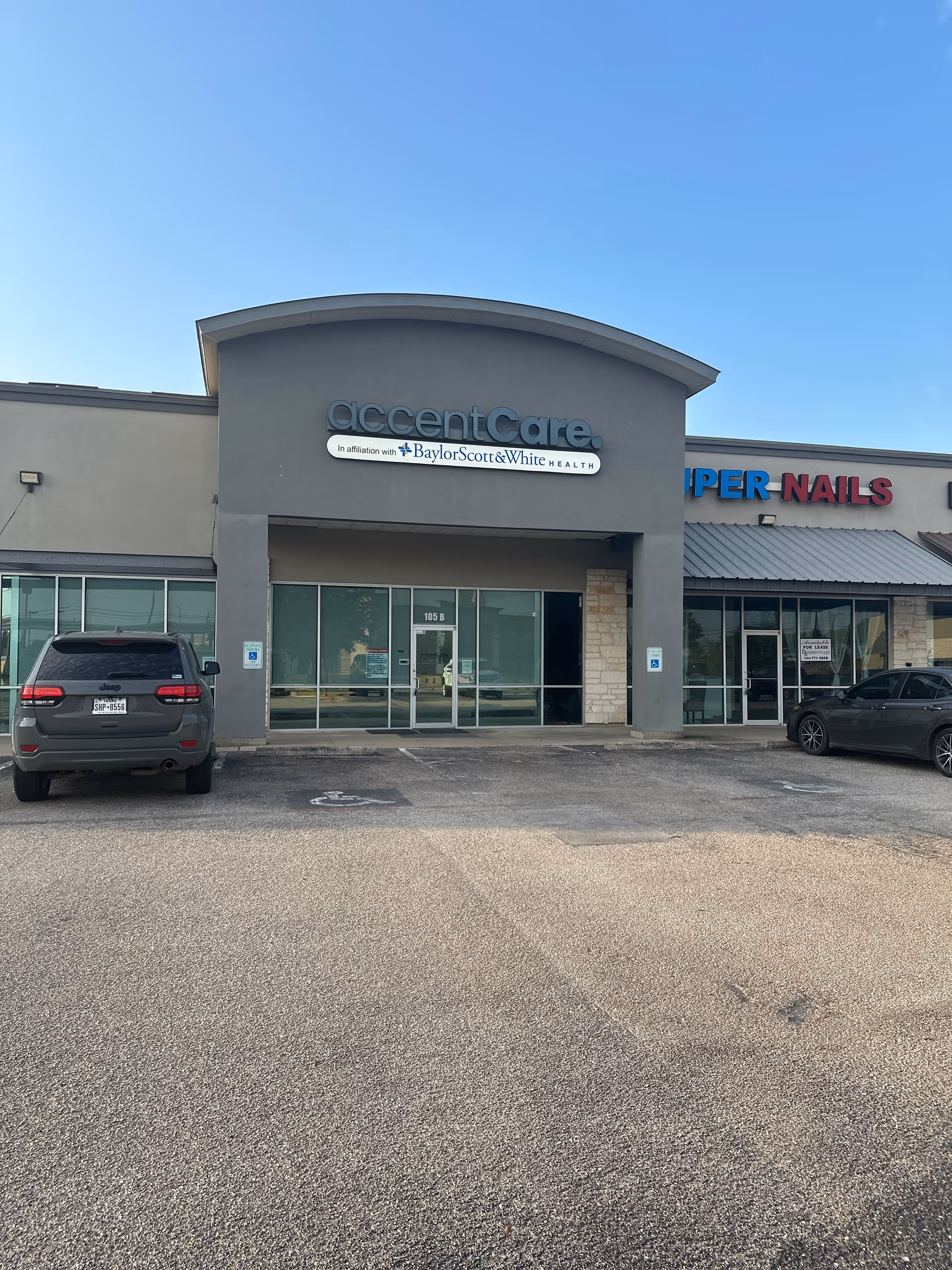 Exterior storefront of AccentCare facility affiliated with Baylor Scott & White Health, with parked cars.