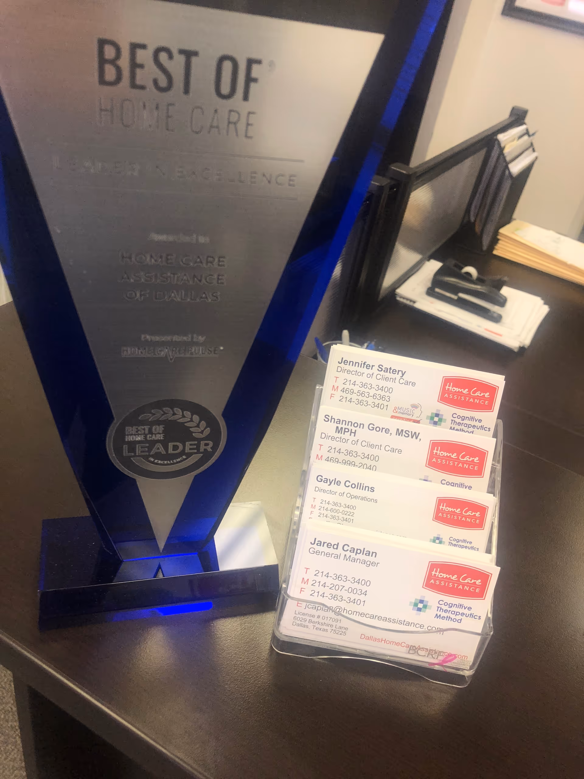 Blue Best of Home Care trophy beside a cardholder displaying Home Care Assistance of Dallas cards.