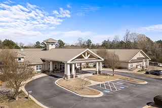 Exterior view of Benton House of Covington, senior living facility with covered entrance and accessible parking.