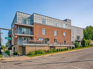 Modern brick-and-glass senior care building on a street corner.