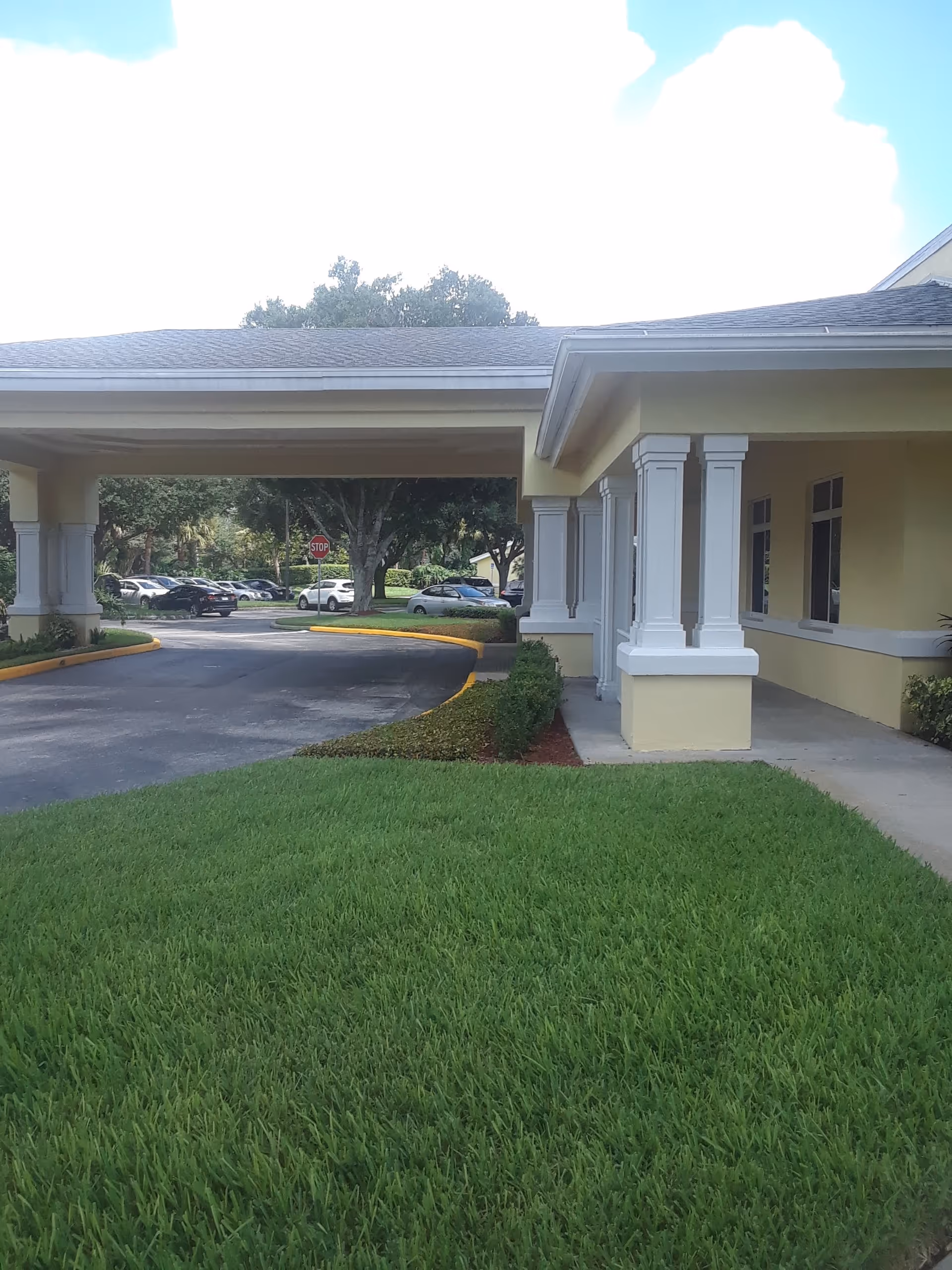 Exterior view of Bedrock at Home Orlando showcasing a covered entrance and green lawn