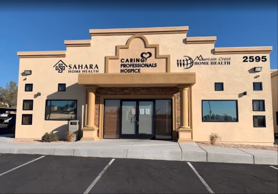 Front view of a beige senior care facility with a glass double door entrance.