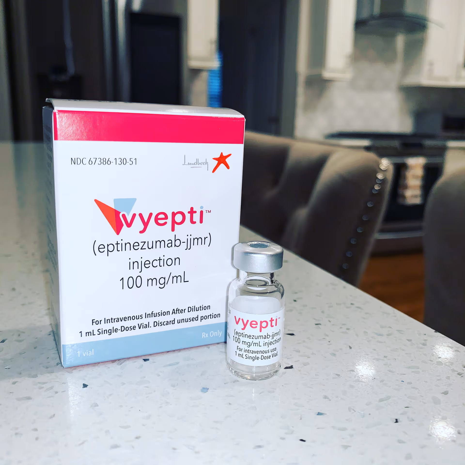 Box and vial of Vyepti (eptinezumab-jmr) injection on a kitchen counter.