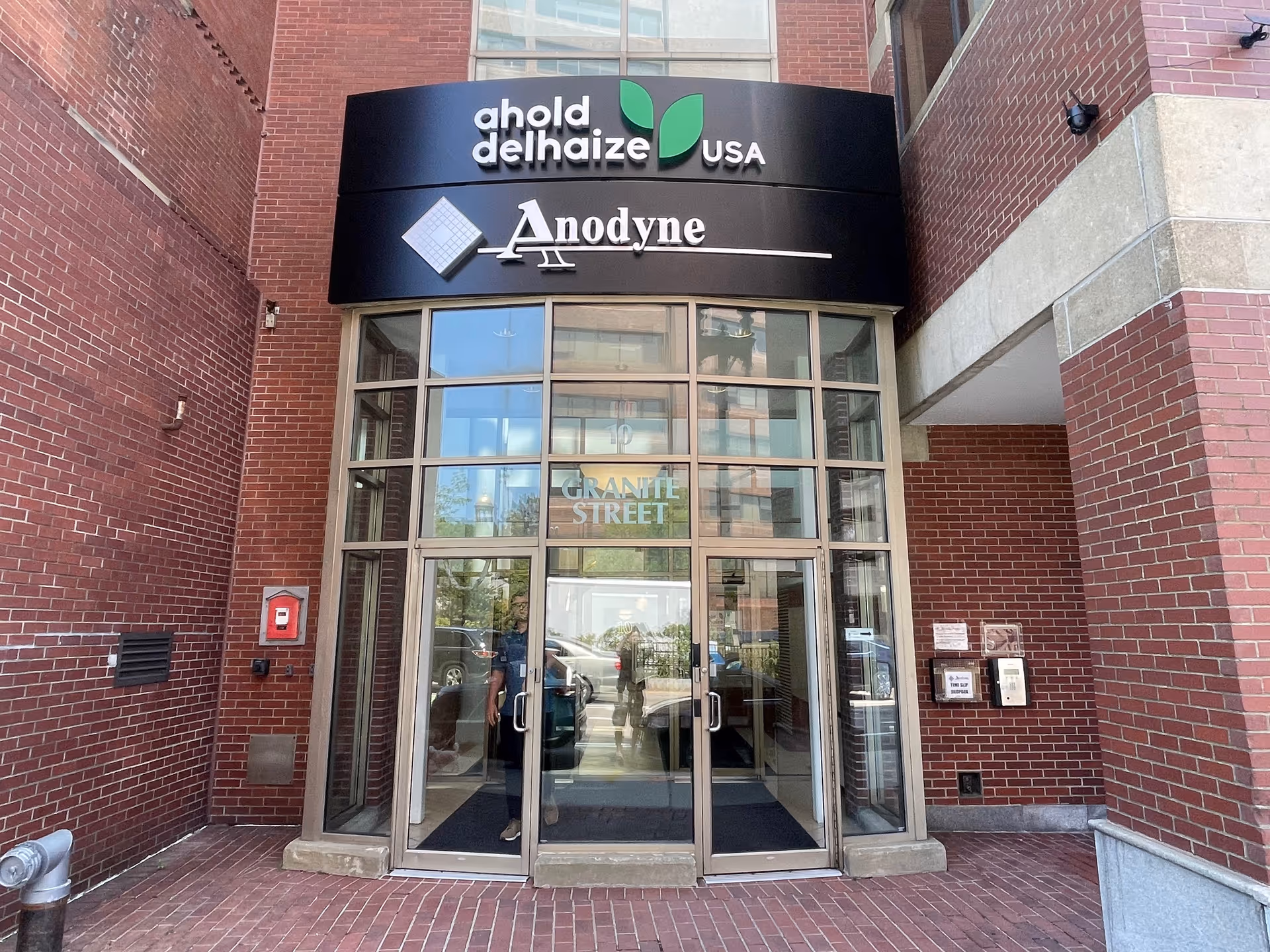 Brick building entrance with glass doors and Anodyne signage.