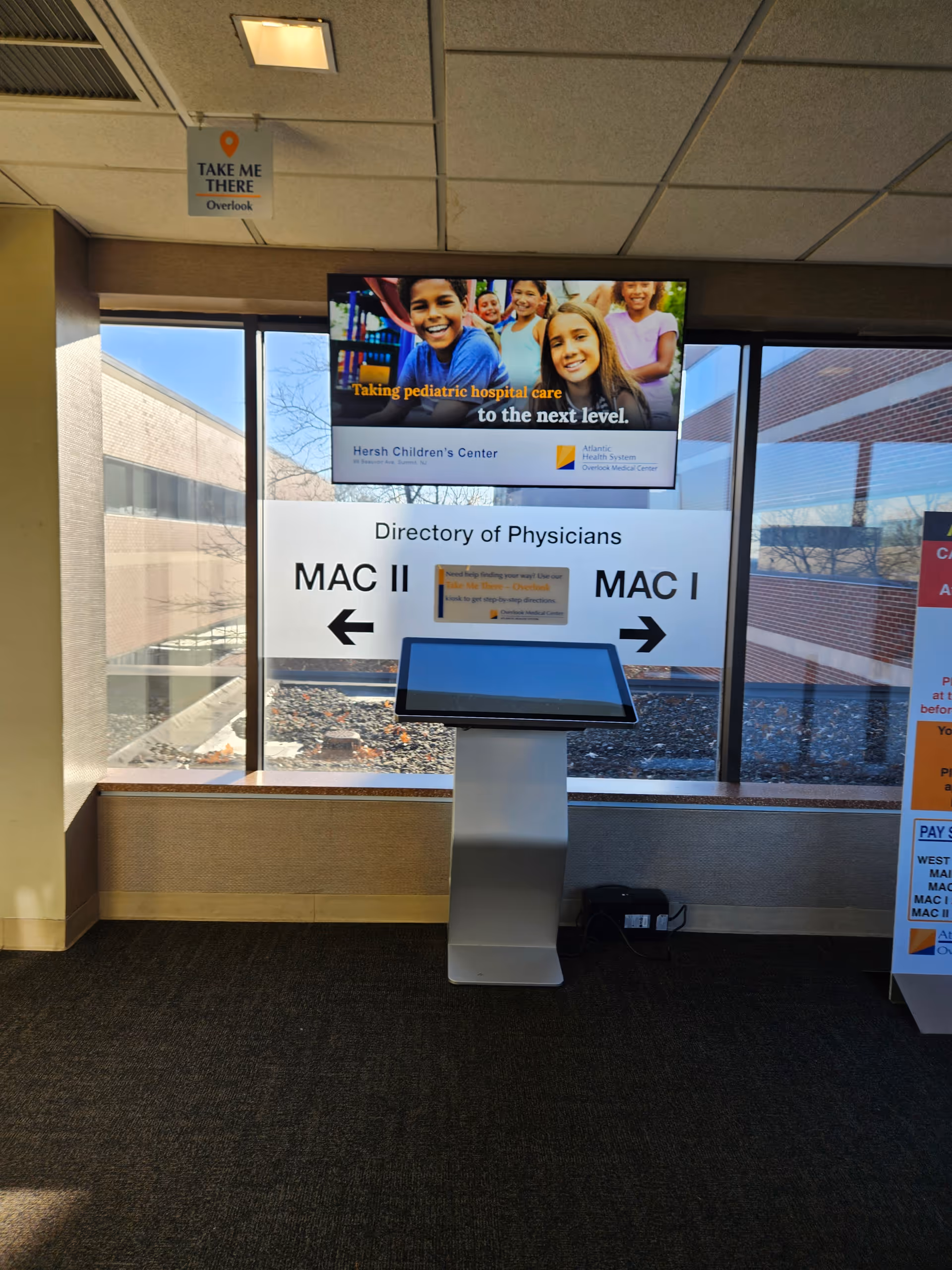 Indoor hospital lobby featuring MAC II directory kiosk and signage.