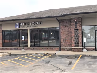 Front view of Horizon Home Care & Hospice facility with parking lot in foreground.