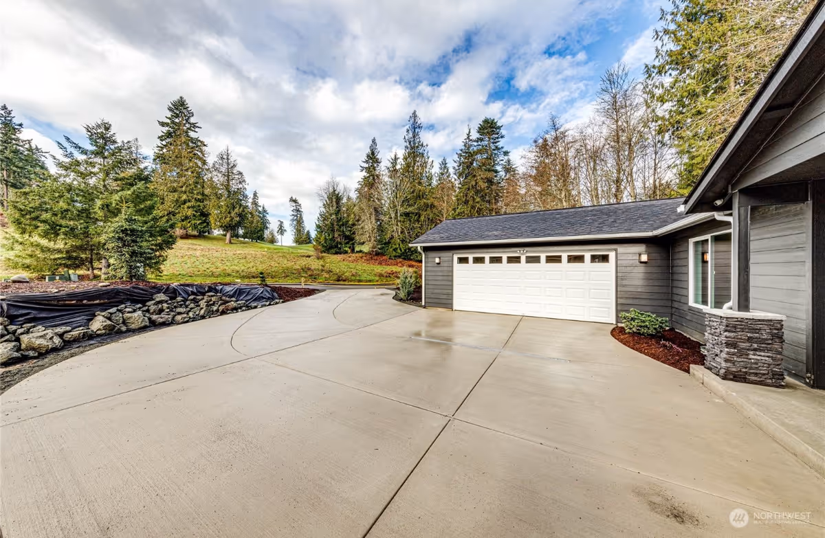 Exterior front view of a modern home with a two-car garage and driveway.