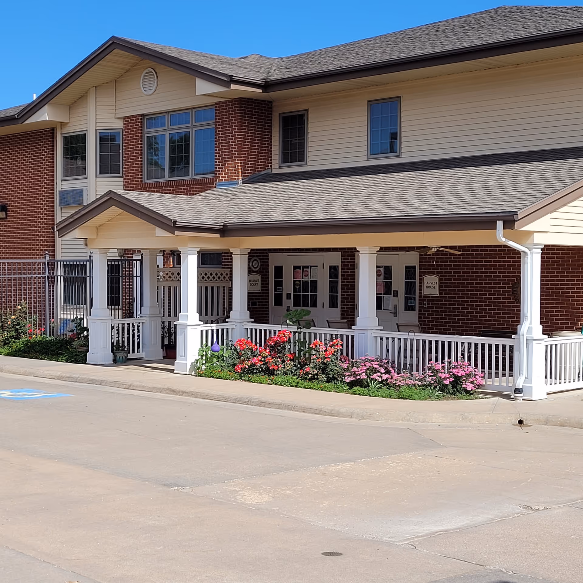 Front view of Pleasant View Home building with brick walls, white porch columns, and landscaping.