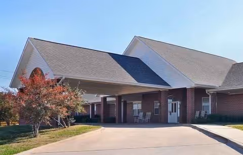 Exterior view of Whitley Place senior living facility entrance with a covered drop-off.