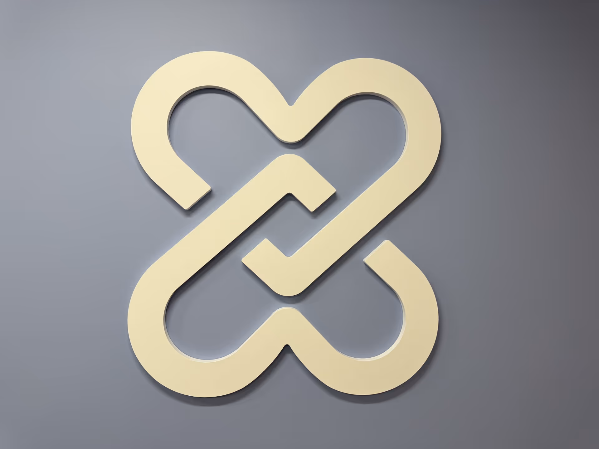 Large abstract beige sculpture mounted on a gray interior wall.