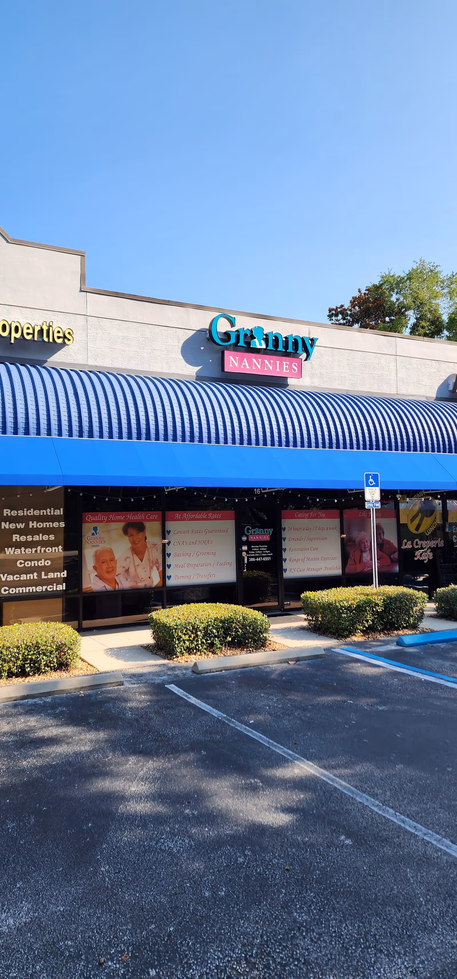 Front of Granny Nannies facility with blue awning and parking lot.