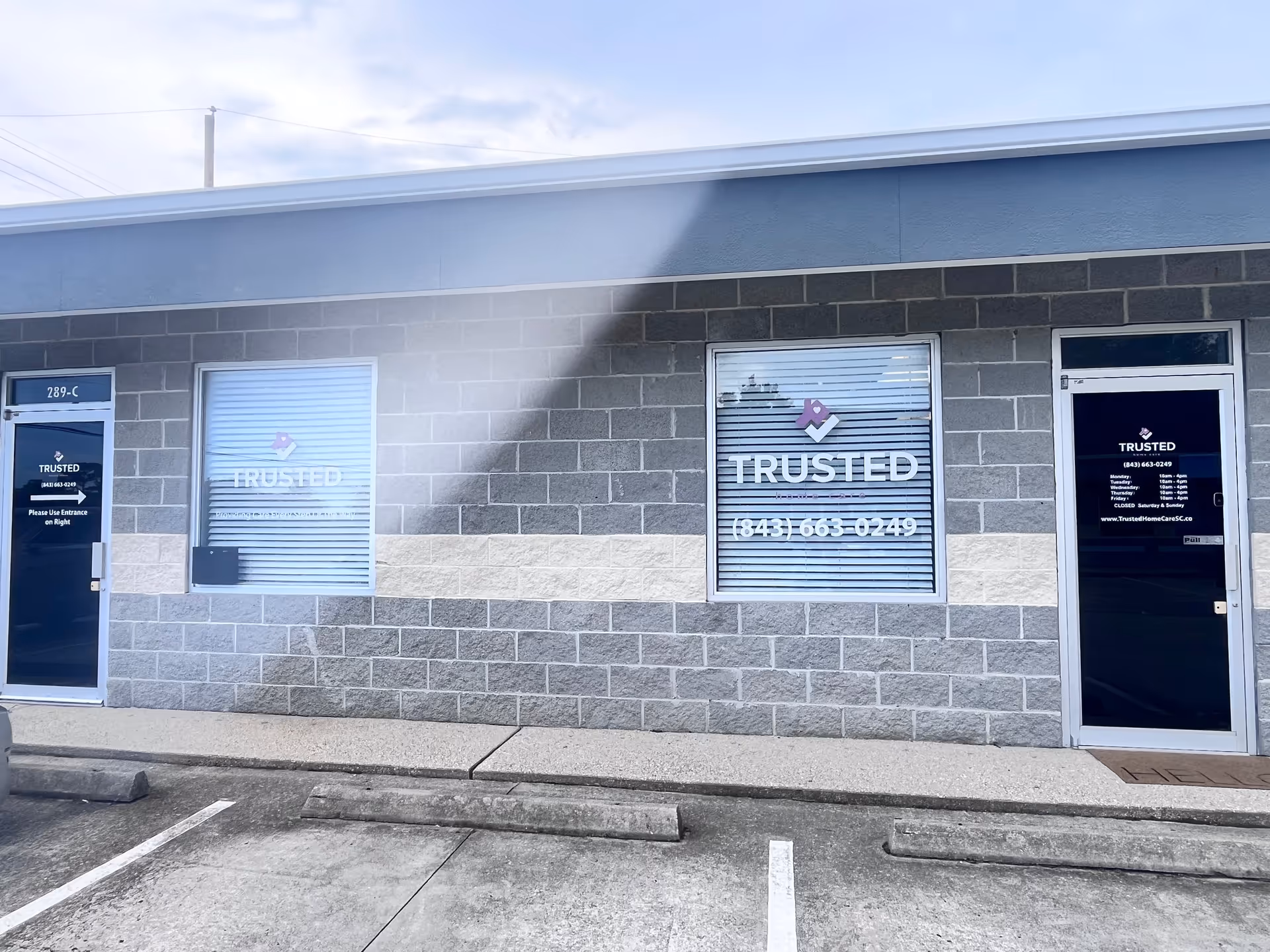 Exterior view of a gray brick building labeled Trusted Home Care.