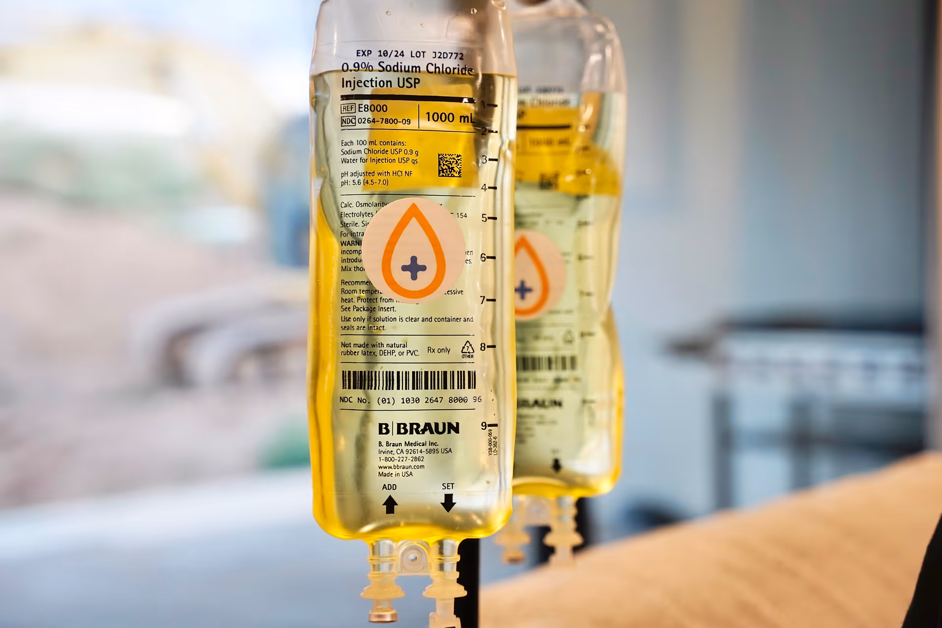 Close-up of yellow IV bags labeled B Braun in an interior care facility.