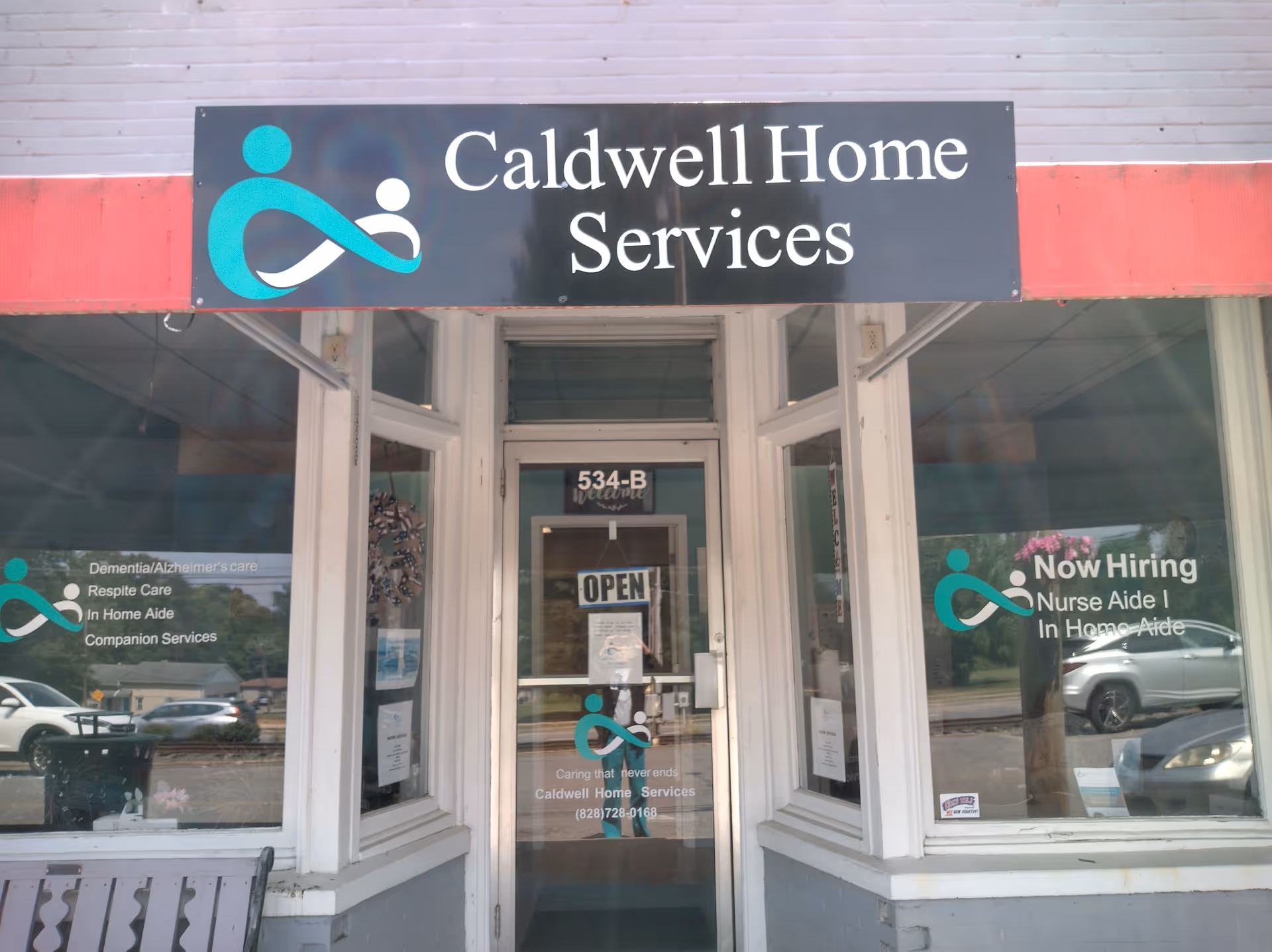 Front view of Caldwell Home Services storefront with signs and hiring notices in windows.