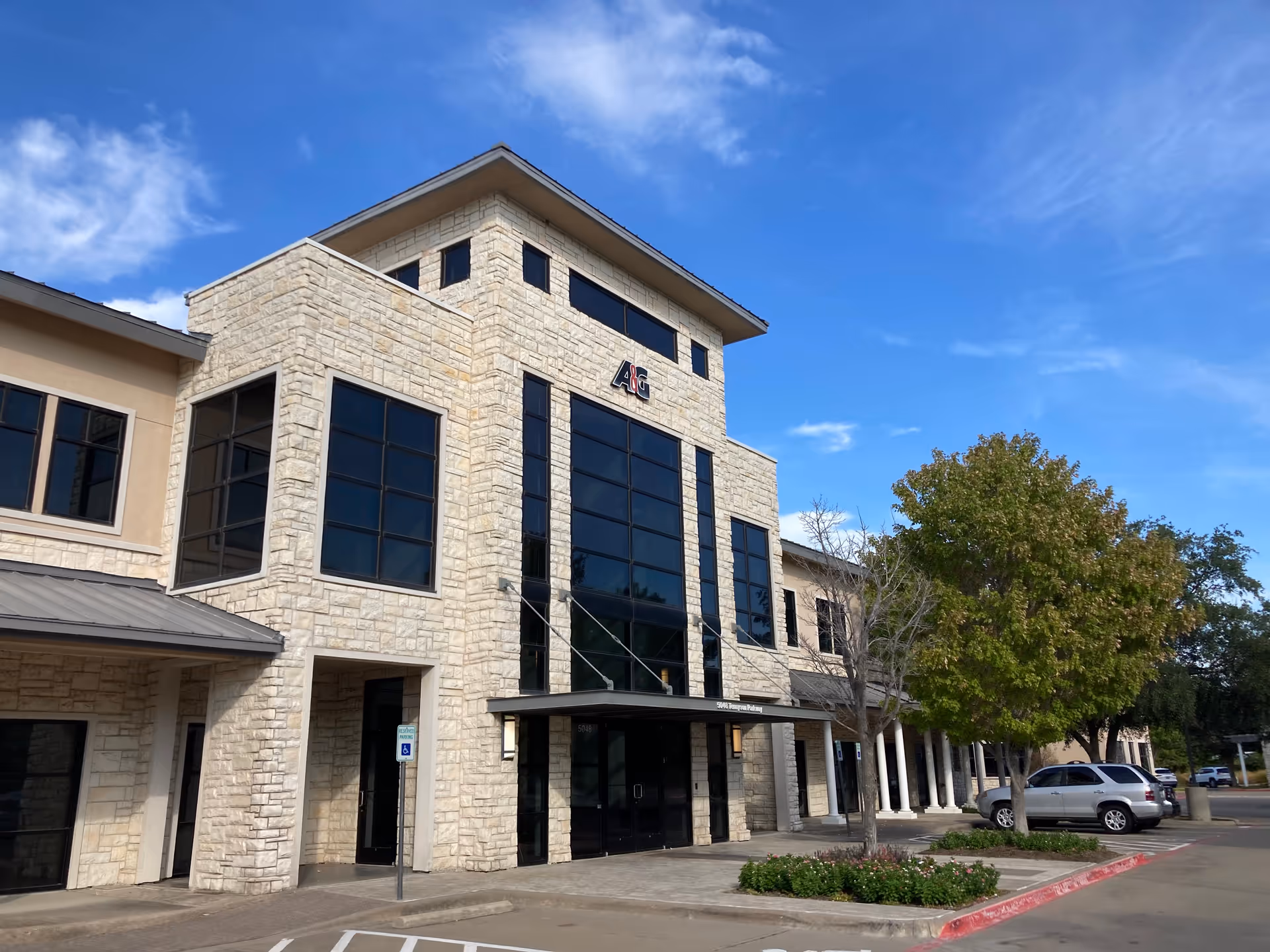 Stone-faced senior care facility exterior with tall windows and a front entrance.