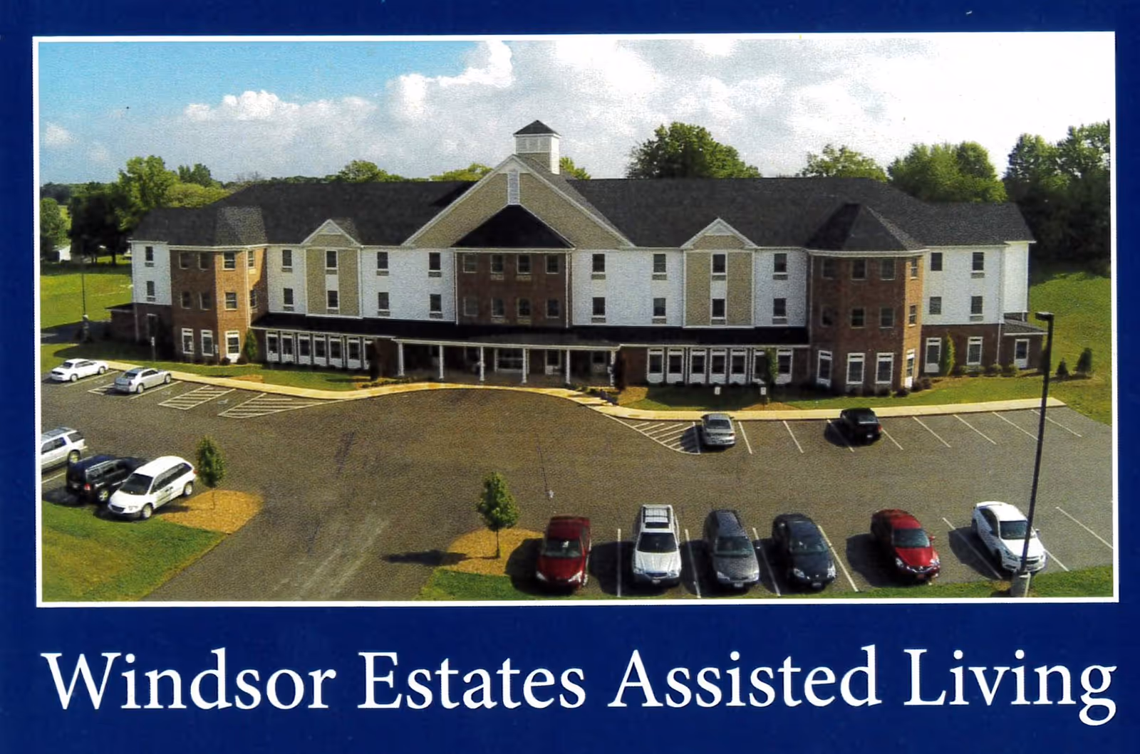 Windsor Estates Assisted Living building with parking lot, framed by a blue border.