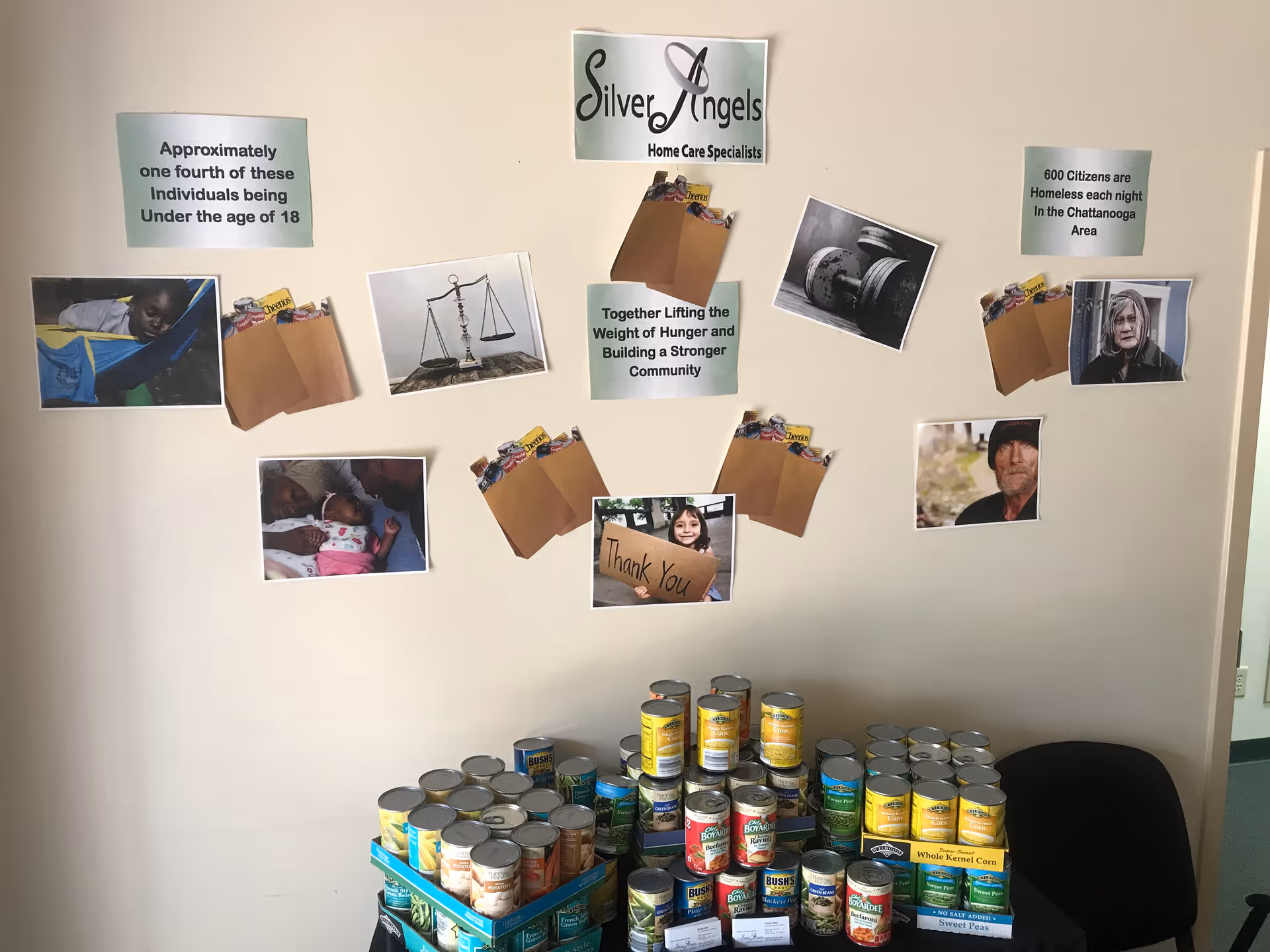 Interior wall at Silver Angels facility; posters, photos, and canned food donations.