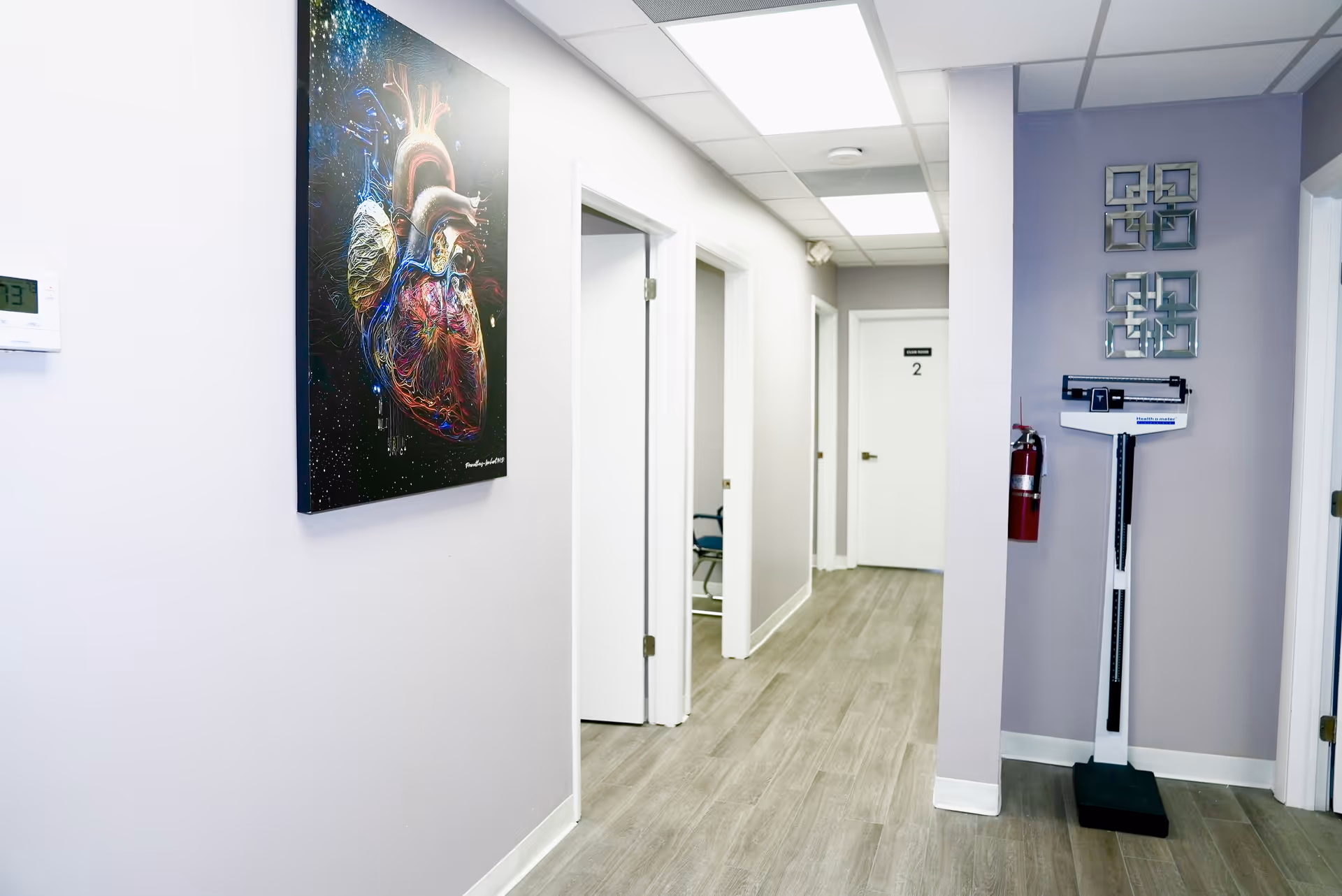 Bright hallway inside a senior living center featuring a large heart artwork on the wall.