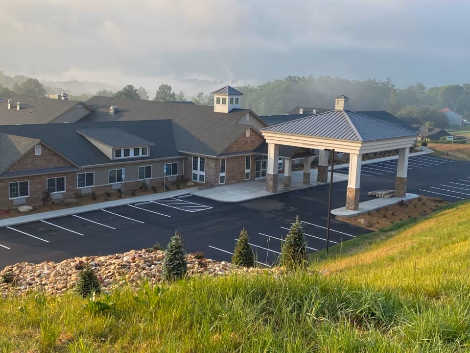 Exterior view of The Landings of Chestnut Grove: brick building with porte-cochere and parking.