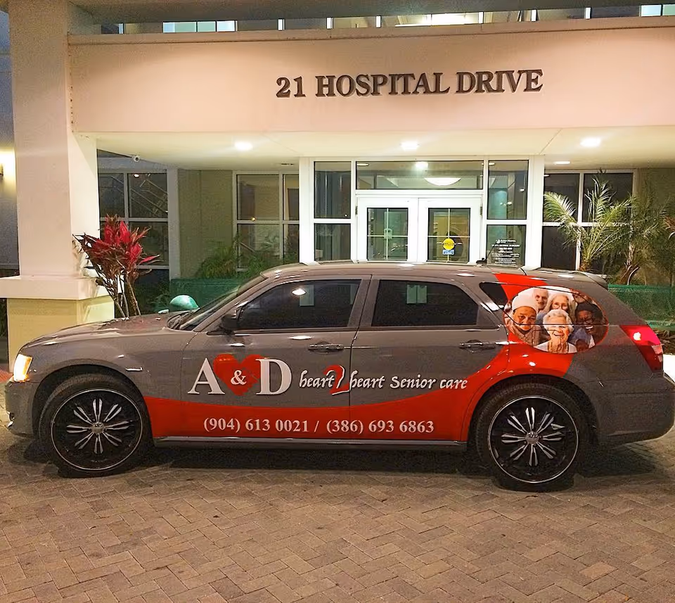 Branded senior care vehicle parked in front of facility entrance.