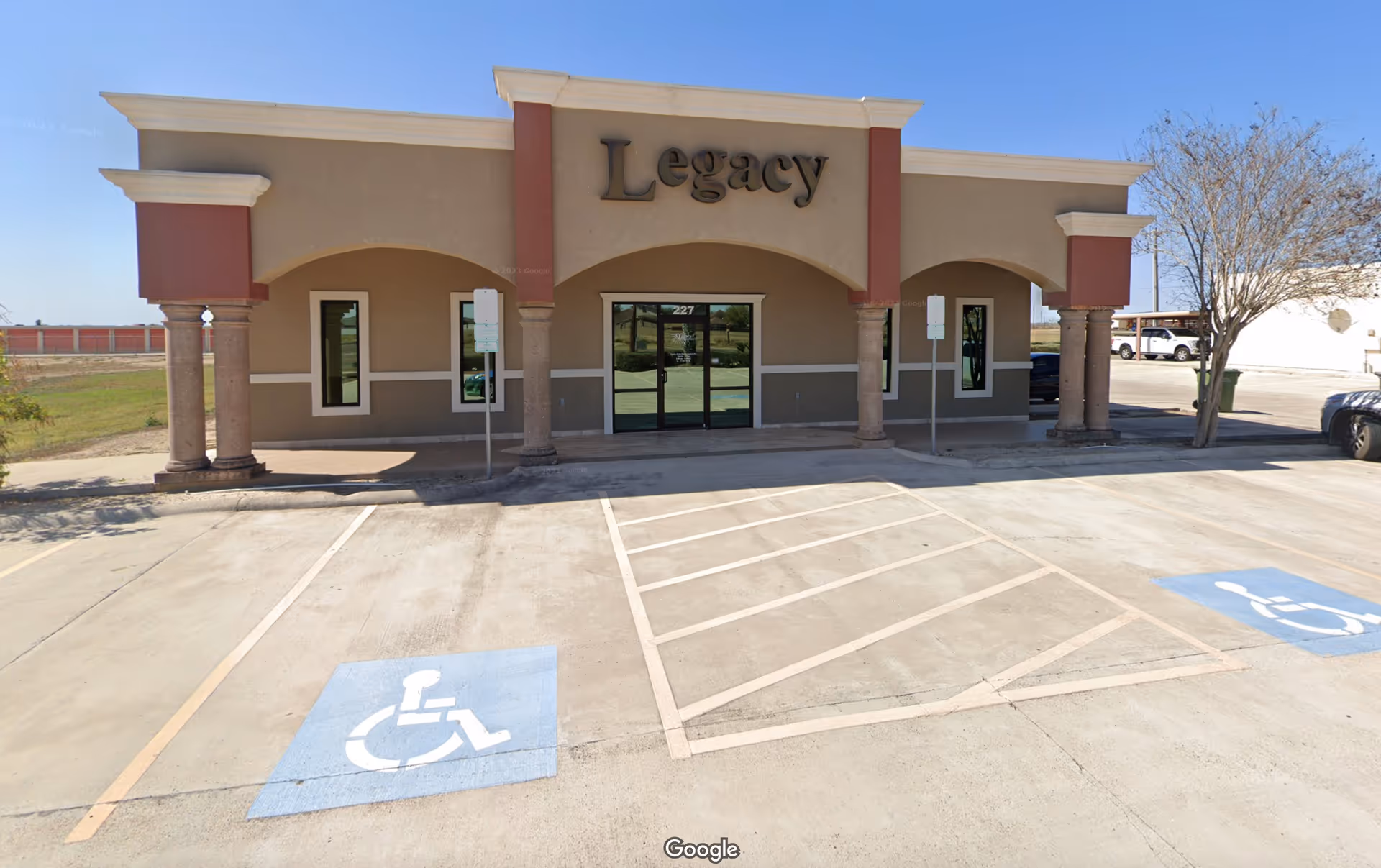 Front of Legacy Home Health Agency building with handicap parking spaces.