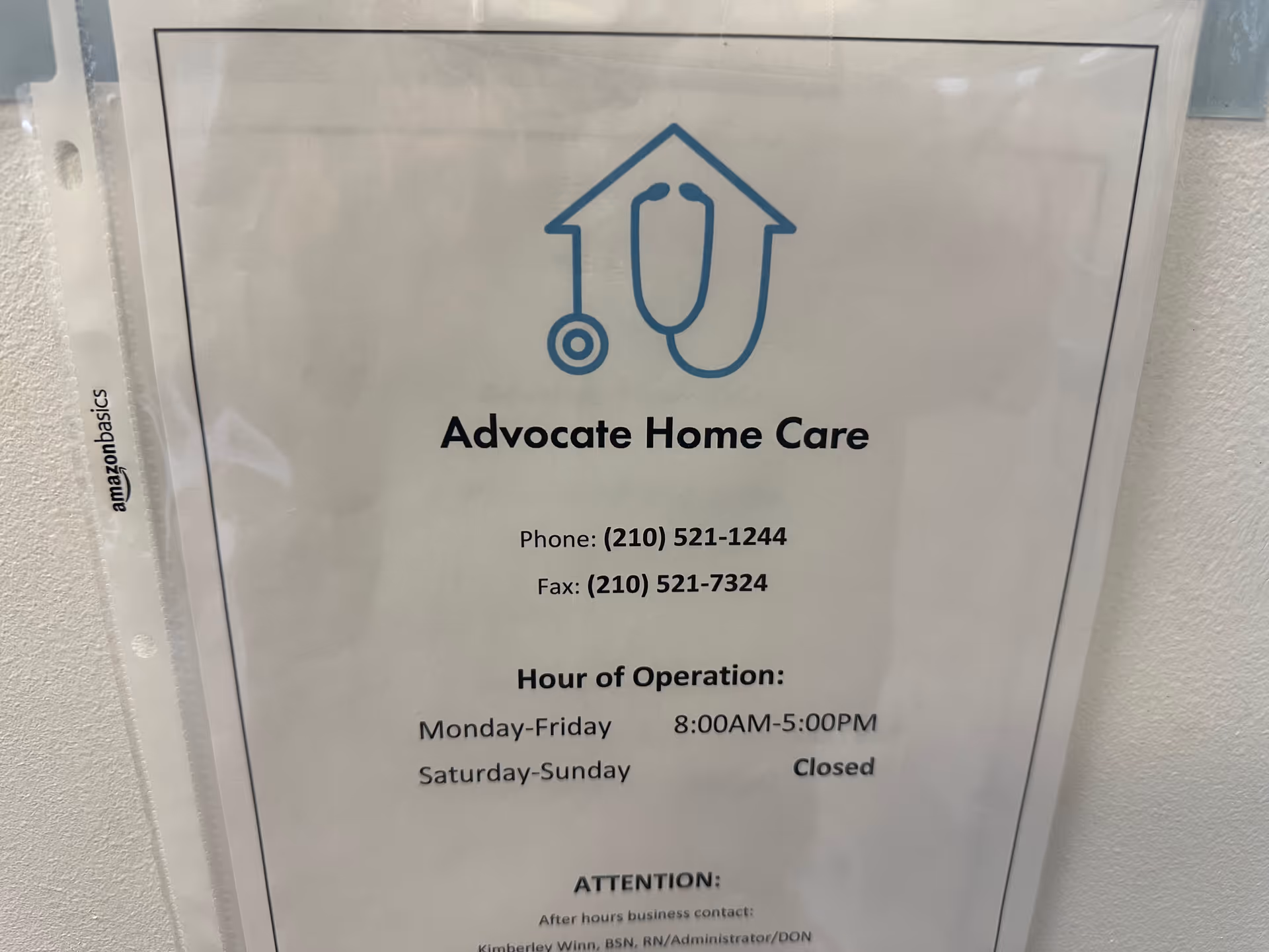 Informational sign for Advocate Home Care with logo and hours of operation posted on wall.
