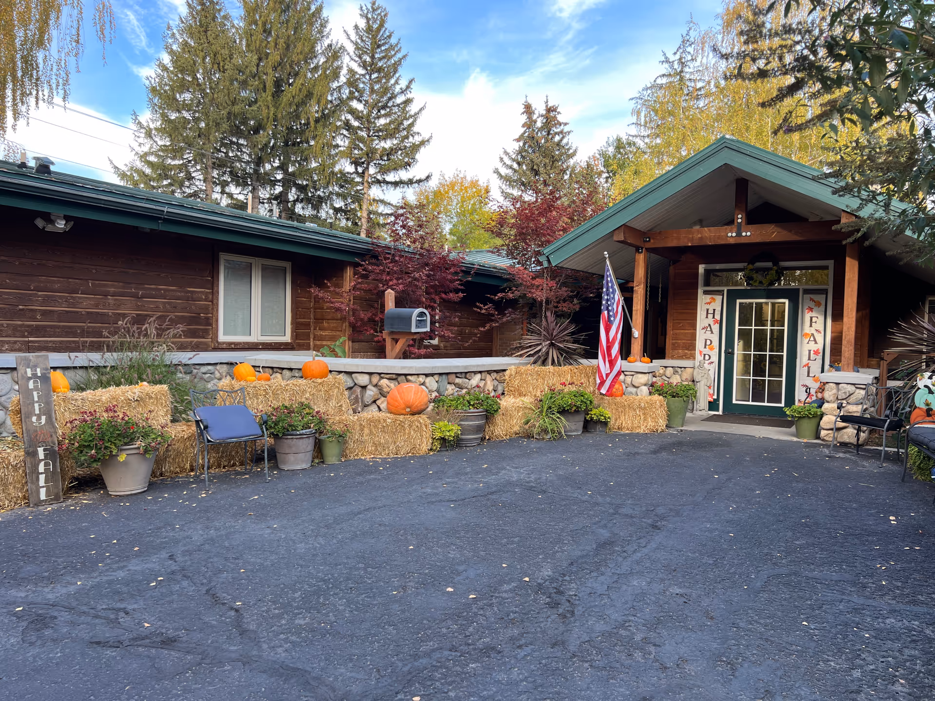Front entrance of Creekside Residential Care Center with fall decorations.