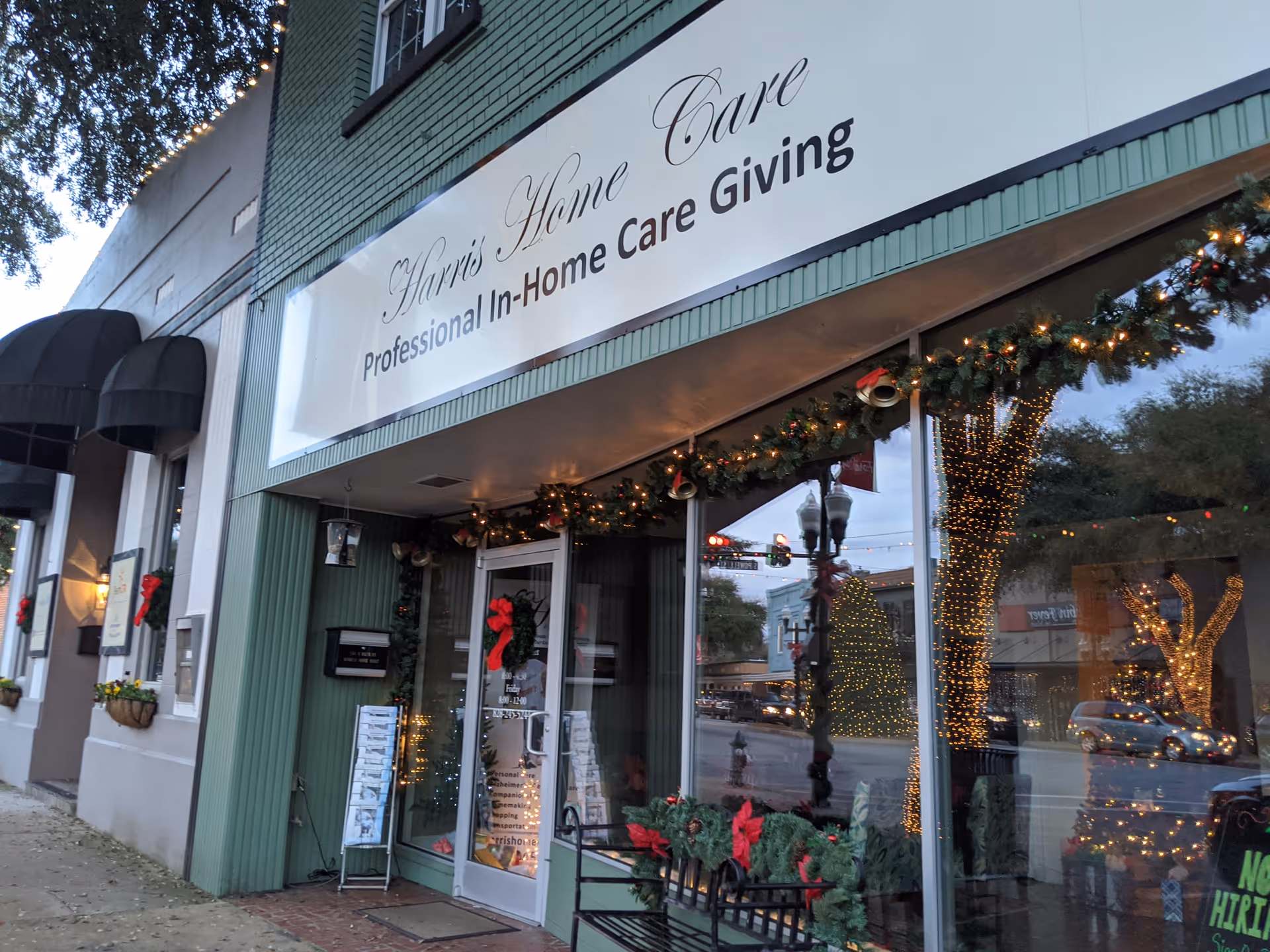 Storefront of Harris Home Care with holiday lights and garland at the entrance