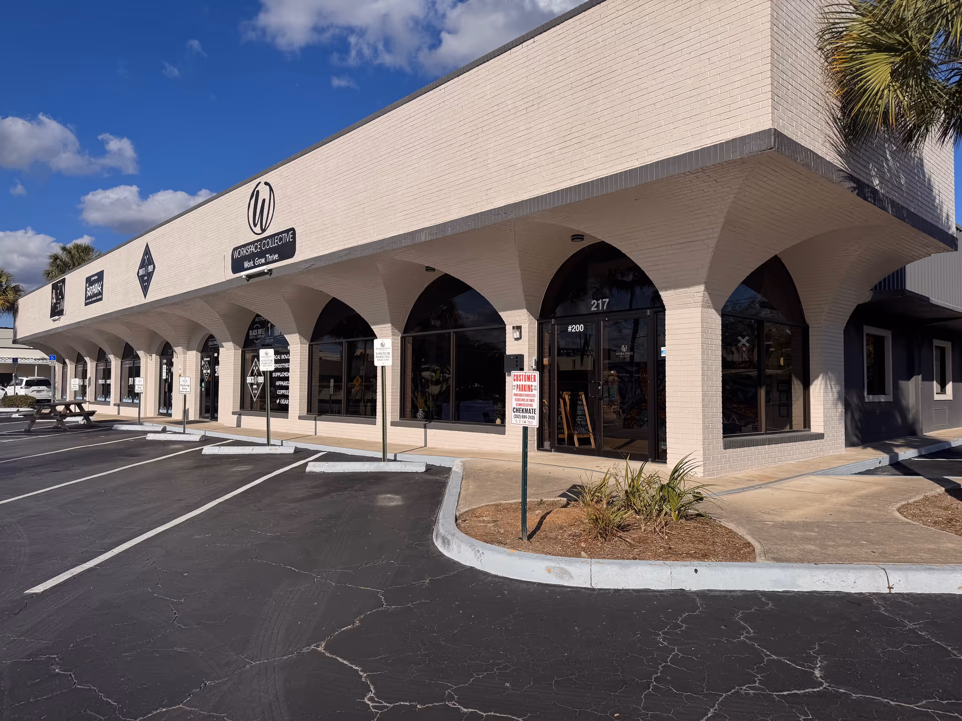 Exterior view of Griswold Home Care storefronts with arches and a parking lot.