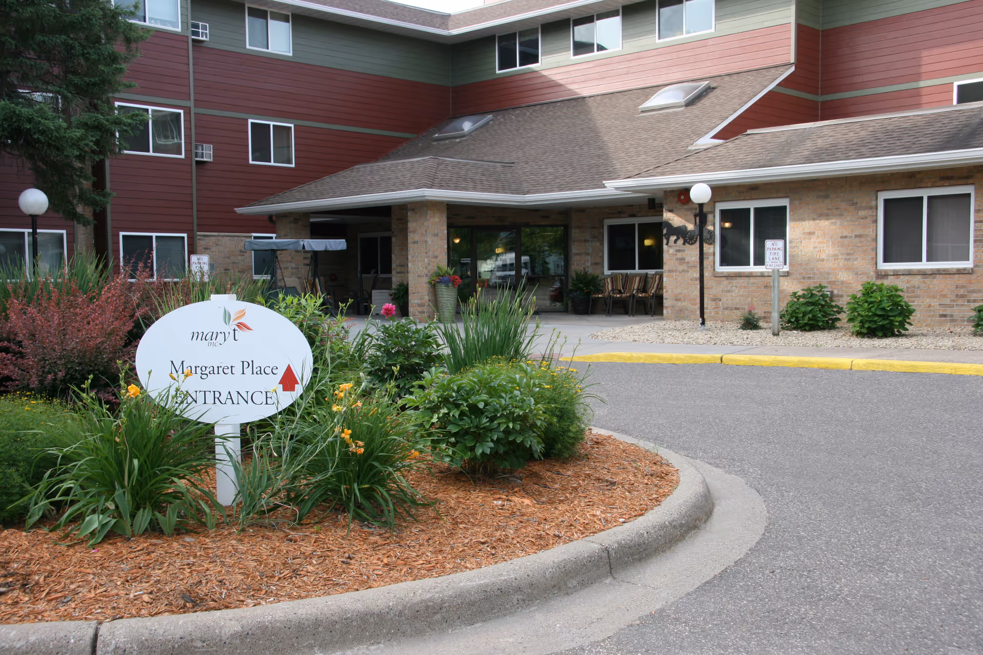 Exterior view of Mary T Inc facility with landscaped entrance and Margaret Place sign
