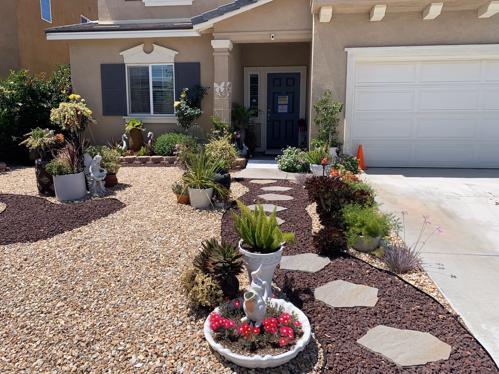 Front exterior of Skypark Assisted Living with a desert landscape and stepping-stone path.