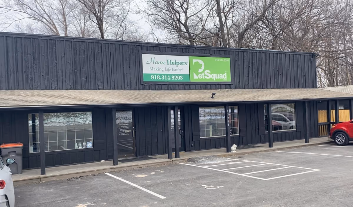 Exterior storefront with Home Helpers sign, black building, and parking lot in Grove, OK.
